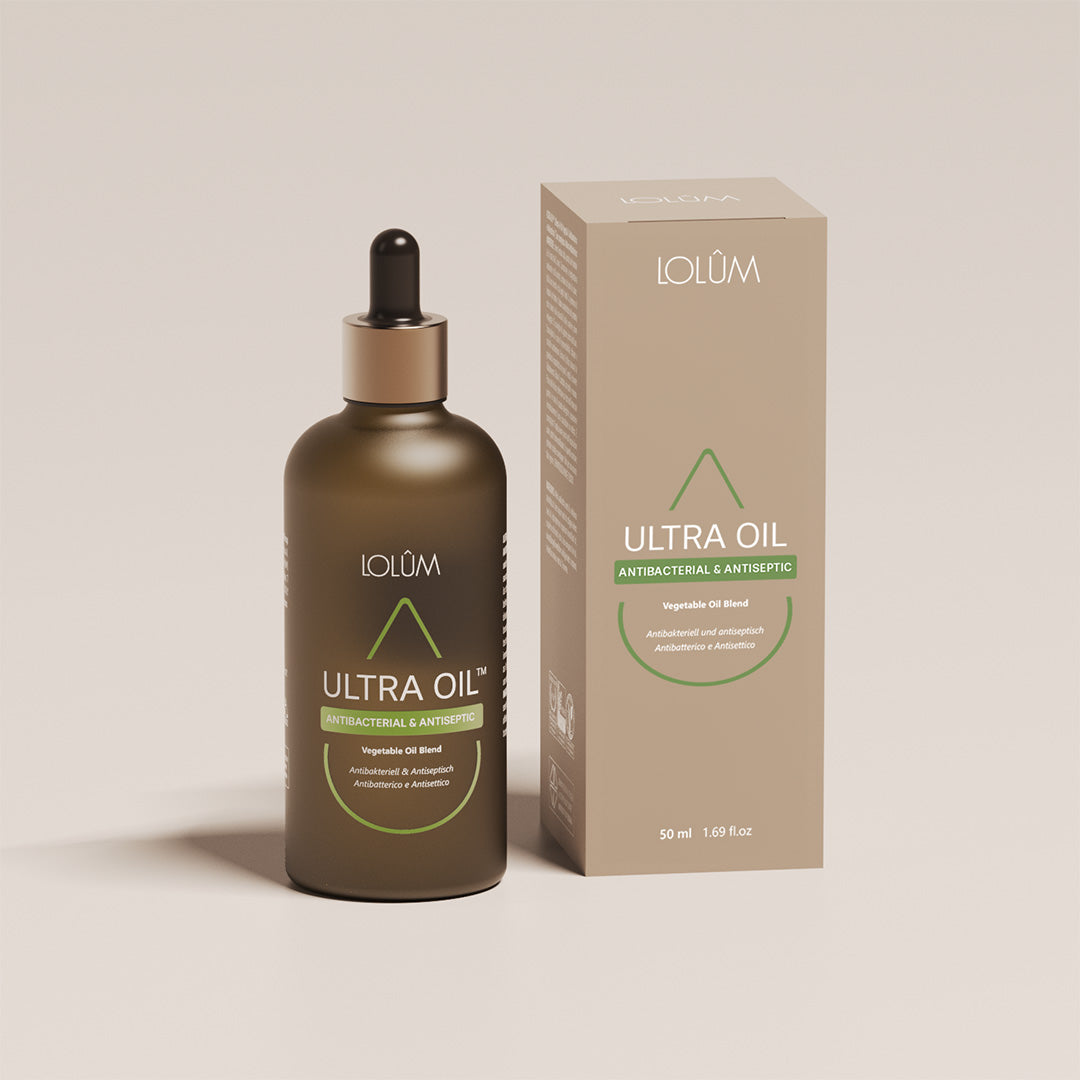 Gouttes d’huile ULTRA OIL™ appliquées sur la peau pour traiter acné, mycoses et irritations cutanées.